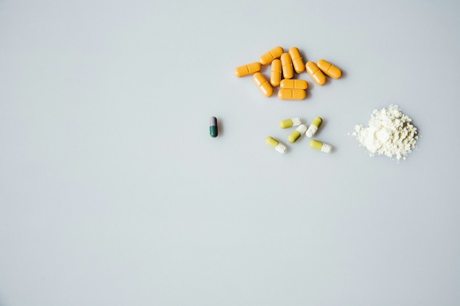 A variety of substances laid out on a plain surface: orange tablets, capsules, and a small pile of white powder.